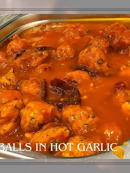 A delicious dish of vegetable balls in a hot garlic sauce, a flavorful Indo-Chinese main course option for your event.