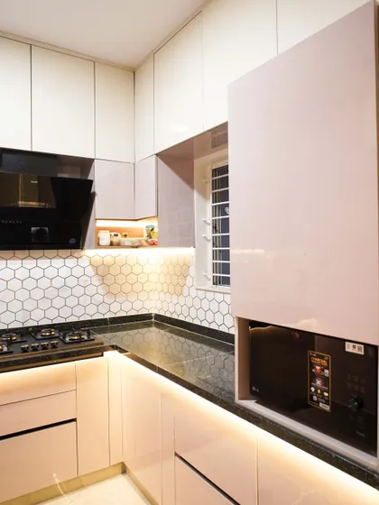 This image showcases a dedicated tall unit with a lift-up door, designed to house a microwave. This keeps the appliance off the countertop, freeing up valuable workspace.
