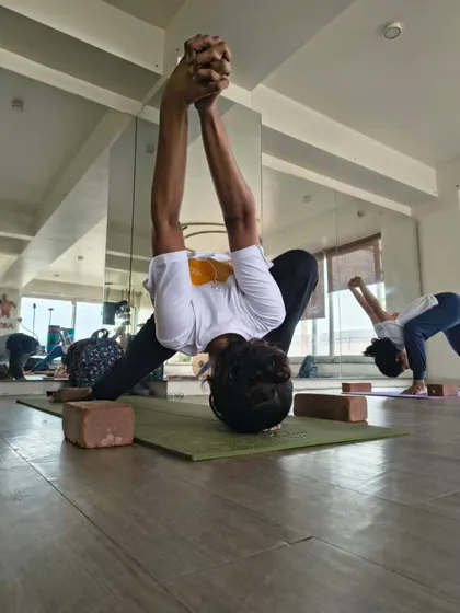 Twisting asanas are a focus in our TTC. This student practices a deep forward-bending twist, learning how such poses detoxify the body and improve spinal mobility.