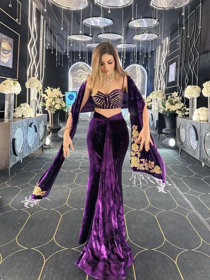 A full view of the stunning black and gold themed walkway I designed for a sangeet. The combination of a patterned floor, hanging mirrored discs, and linear lighting creates a dramatic and glamorous entrance.