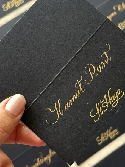 Timeless copperplate calligraphy place cards for a St. Hugo Wines sit-down event at The Ritz-Carlton, Bangalore. These personalized gold-on-black cards added an elevated, formal touch to the gathering.