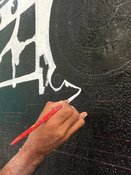 Another close-up of the painting process, showing how we build up layers of paint to create bold, opaque graphics for our gym murals.
