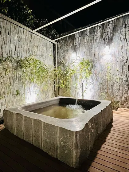 Water gently fills the stone tub, adding a soothing sound to this tranquil space.