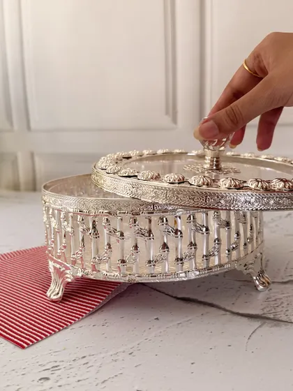 Lifting the lid reveals the spacious interior, perfect for holding a generous amount of treats. This piece beautifully marries form and function.