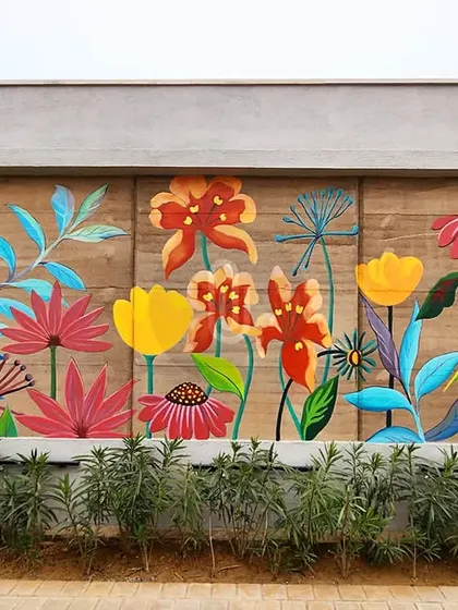 A stylized floral mural featuring a variety of colorful, imaginative flowers. This piece combines different shapes and hues for a playful and artistic take on a garden scene.