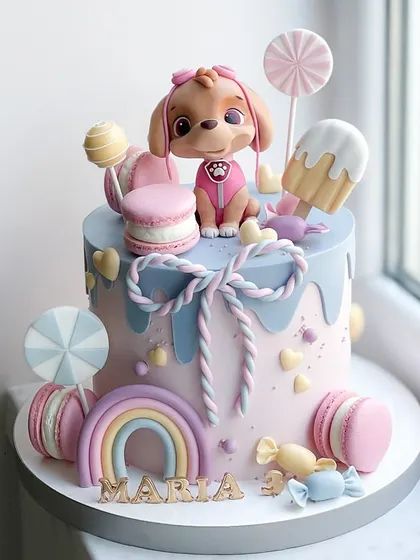 A cute and colorful cake for a dog lover, featuring a fondant puppy, a rainbow, and candy-themed decorations like macarons and lollipops.