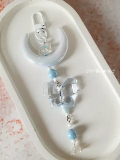 The blue version of my moon and butterfly charm, perfect for adding a touch of serene, dreamy color to your accessories.