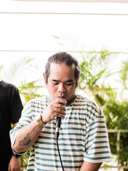 Mic check, one two. A shot of me on the microphone, always ready to hype up the crowd and get the party started.