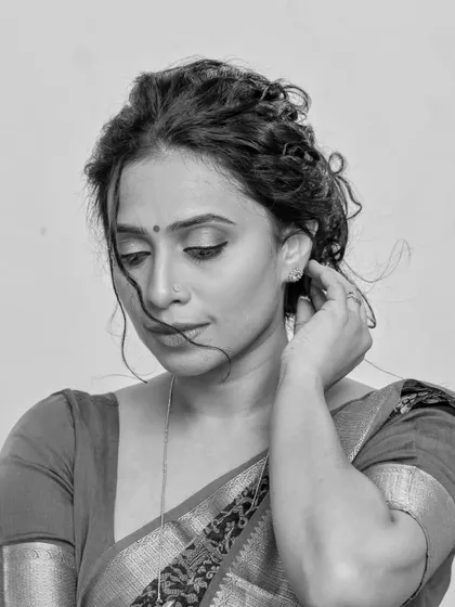 A series of studio portraits featuring a model in a black and red printed saree. The images range from expressive close-ups to elegant full-body shots, demonstrating versatile studio lighting.