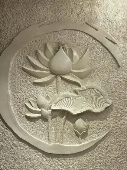 A clean, crisp shot of the finished white lotus mural against its textured background, highlighting the purity of the form and the fine details of the petals.