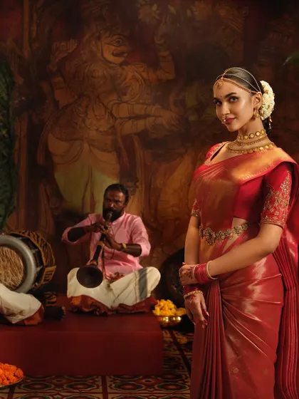 A closer look at the elegant drape on this red silk saree for a Pothys campaign. The pleats are kept sharp and the pallu is styled to create a regal look.
