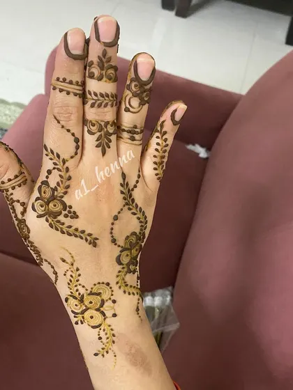 A very light and minimal design with small floral elements scattered across the hand.