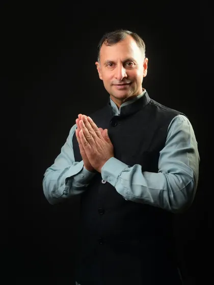 A portrait for a political profile, using the traditional 'namaste' gesture. This pose communicates respect, humility, and a connection to Indian culture, which is vital for a public figure.
