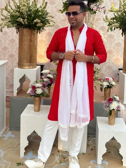 A relaxed pose in my red kurta. This outfit is comfortable yet stylish, allowing me to move freely while hosting.