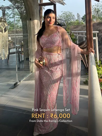 A pink sequin lehenga set with a modern slit and a sheer cape. A chic and glamorous look.