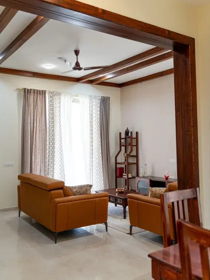 An alternate view of the living room, showing how the solid pine wood rafters and door frame create a beautiful, cohesive look that guides the eye through the space, connecting the living and dining areas.