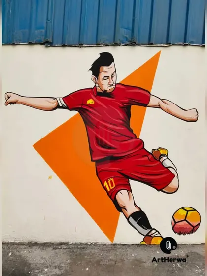 A detailed shot of a football player mid-kick from the Gurgaon sports mural. We focus on capturing a sense of power and motion in our sports-themed art.