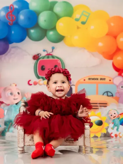 The star of the show in her Cocomelon world. A bright and cheerful first birthday portrait.