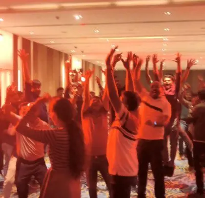 The energy is high as the ABB team dances under intense red lighting.
