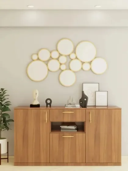 A classic wooden sideboard offers ample storage for this entryway. The bubble-like cluster of mirrors on the wall adds a playful and artistic touch to the functional design.