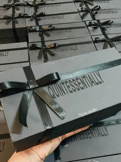A full view of the finished corporate gift boxes for "Quintessentially," all tied with a black ribbon. This shows our attention to detail and our ability to deliver a large volume of professionally packaged gifts.