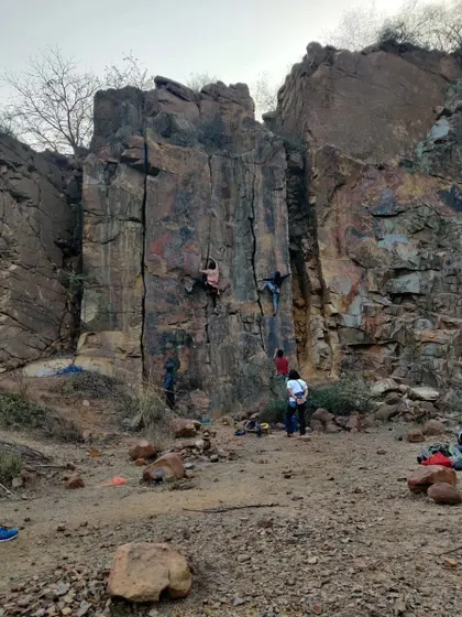 Climbers spread out across the crag at Dhauj. Roped climbing allows multiple people to climb different routes at the same time, making for a dynamic day outdoors.