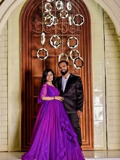 Another shot of this picture-perfect couple. The elegant purple gown is a fantastic choice for an evening pre-wedding shoot with dramatic lighting.