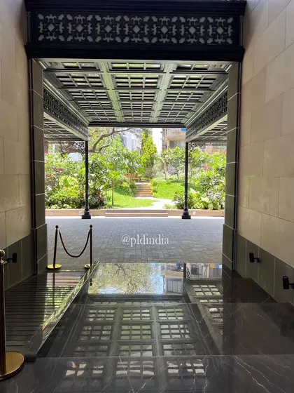 The formal entrance to the building, with its polished marble floor, reflects the garden outside. This shot emphasizes the strong visual connection I aim to create between interior and exterior spaces.