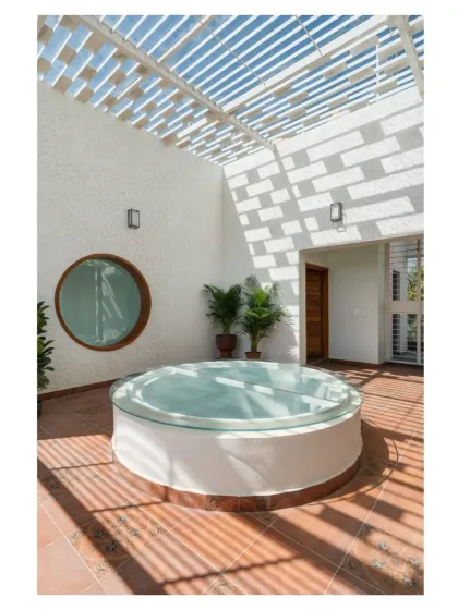 This terrace lounge is designed around the interplay of light, shadow, and geometry. A pergola casts dynamic patterns across the floor, while a circular skylight adds a unique architectural element, making this a special place to unwind.