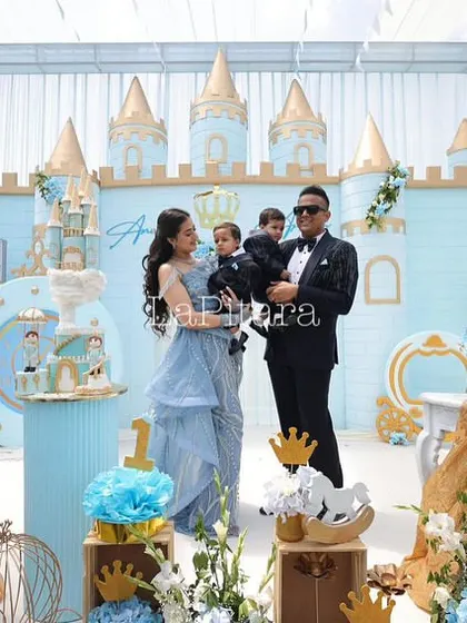 A beautiful family portrait in front of the custom-designed prince castle backdrop. This photo captures the joy of the moment and showcases how the decor serves as a perfect setting for creating lasting memories.