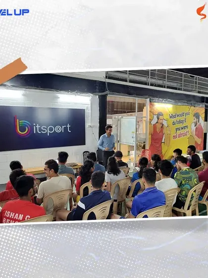 The interactive format of our mental conditioning workshops allows for open discussion and learning. The motivational poster in the background, "What would you do today if you were not afraid?", reflects our coaching philosophy.