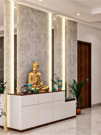 Vertical light panels create a dramatic effect in this foyer. The design features a long console table with a seated Buddha, providing a serene and well-lit welcome.