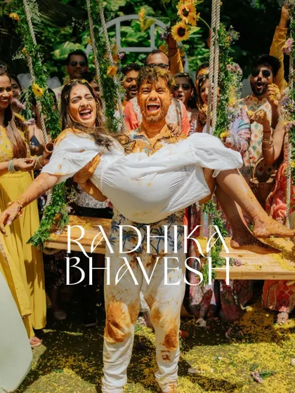 The groom carrying the bride after a very messy and happy Haldi. This is a hero shot for any fun-loving couple.