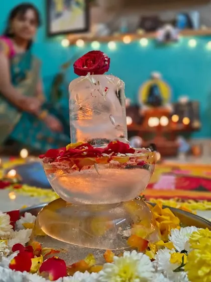 My home setup for Mahashivratri, featuring a handmade ice lingam adorned with flowers. My art is deeply connected to my spiritual practices.