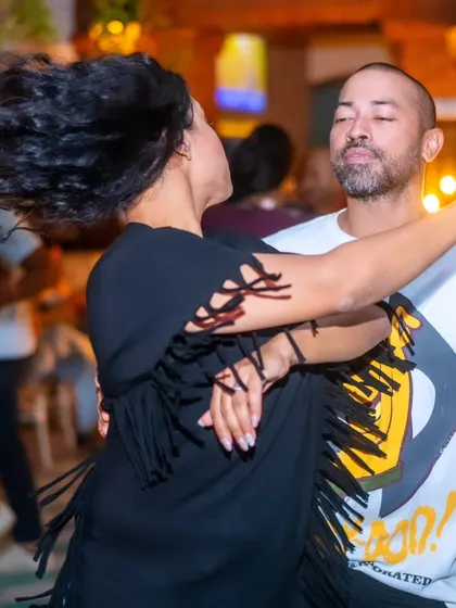 A candid moment of social dancing. This is what it's all about: moving to the rhythm, connecting with your partner, and letting your hair fly.