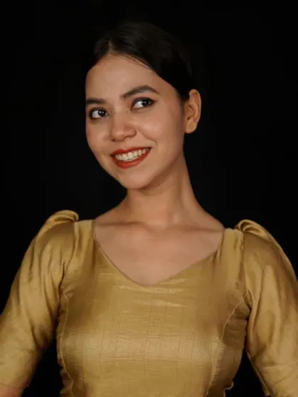 A golden blouse with puffed sleeves and a V-neck, offering a touch of classic charm.