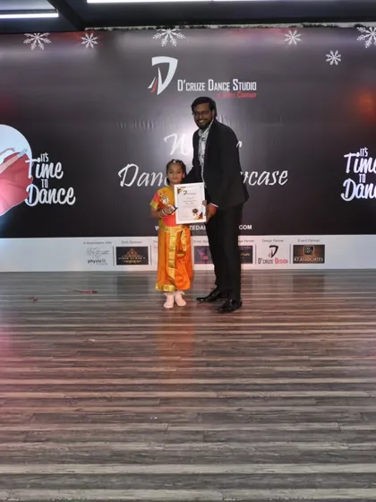 Celebrating our students' achievements with an award at the D'cruze Awards ceremony.