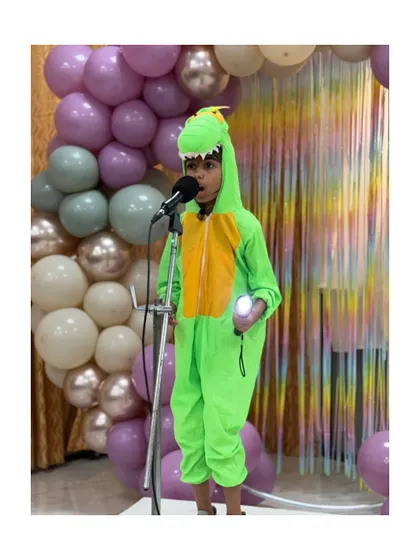 Even in a dinosaur costume, this young performer delivers his monologue with focus and character, showing that confidence comes in all forms.