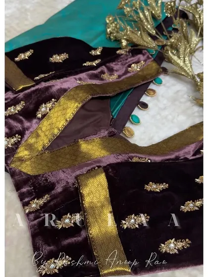 The back of the plum velvet blouse, showing how the zari border is used to create a unique and elegant pattern.