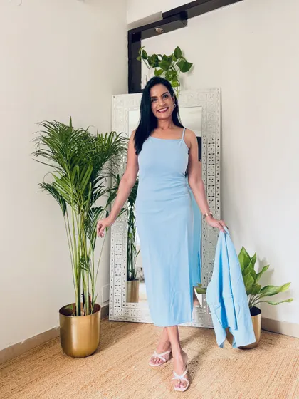 The same powder blue outfit, showing the strappy dress without the shrug. It's a beautiful summer dress that can be worn for a casual day out.