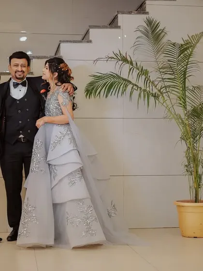 A candid moment of the couple sharing a laugh with a family member. These interactions are a precious part of any wedding event.