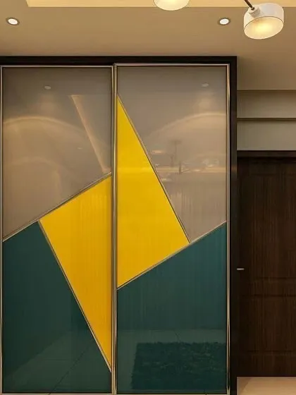 This sliding wardrobe makes a bold statement with its geometric color-blocked design in teal and yellow. It's a perfect way to add personality and a splash of color to a modern bedroom.