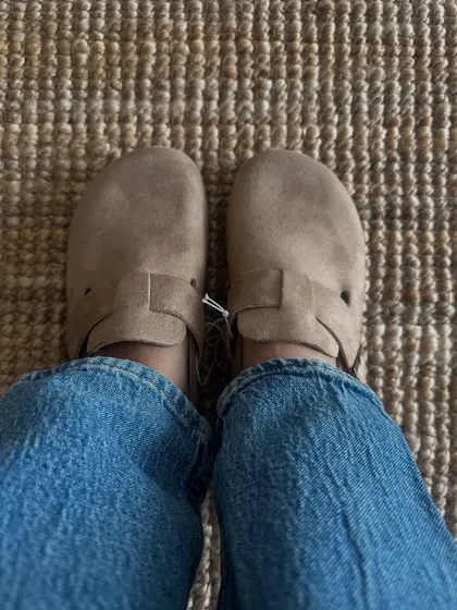 A customer trying on the same clog style, this time in a lighter taupe colour. It's a great neutral that goes with everything.