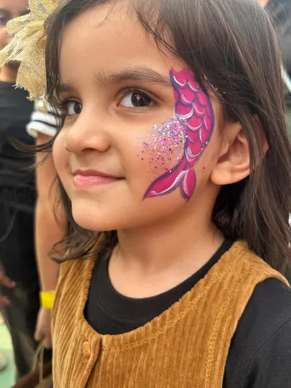 A magical mermaid look for this little sweetheart. The shimmering scales and glitter were a huge hit at the party.