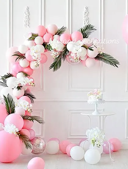 A delicate and pretty balloon arch in shades of pink and white, perfect for a first birthday or a baby shower. I incorporated white flowers and green leaves into the garland to give it a soft, organic feel against the clean white wall.