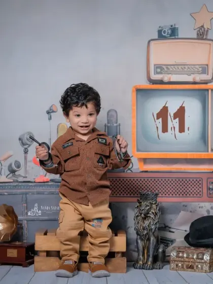 Celebrating an 11-month milestone with a retro flair. I can customize the props, like adding the number '11' to the vintage TV screen, to personalize your baby's photoshoot.