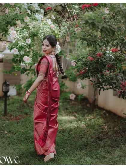 A beautiful shot of the bride from behind, showing off her intricate hairstyle and the drape of her saree.