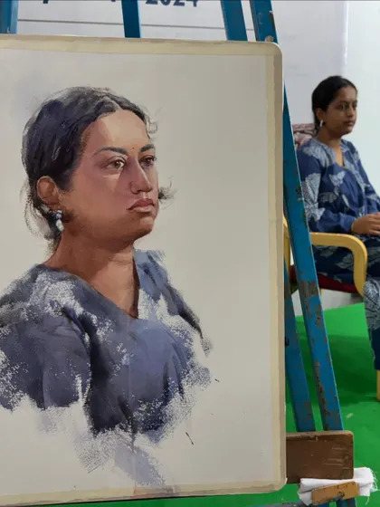 The finished portrait next to the live model. This helps the audience see how I've interpreted her features and expression.
