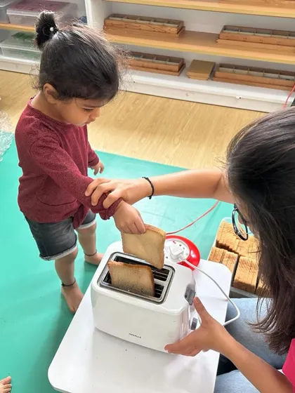 Each activity, from making Bhel Puri and toast to plucking methi leaves and exploring what floats, is a lesson in itself. These practical life and sensorial activities are central to the Montessori method, helping children develop fine motor skills, concentration, and a deep understanding of the world through their own actions.