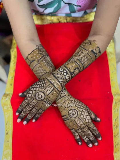 Another view of the engagement mehndi with initials and rings, showing the full design across both hands.